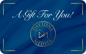 A blue gift card featuring the text 'A Gift For You!' and the logo of Daytona MedSpa.